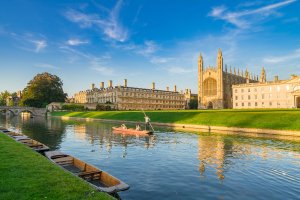 View of Kings' College Chapel in Cambridge with people punting on river cam