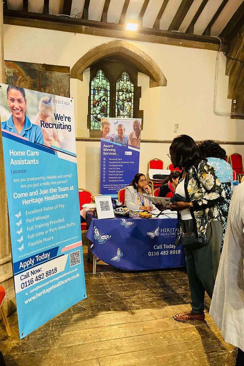 Directors, Deepti and Subhadra, giving two women with short dark hair, wearing floral tops, information about what its like working for Heritage Healthcare Leicester.