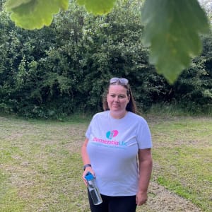 Director and Registered Care Manager, Tanya, wearing a Dementia UK t-shirt and holding a Heritage Healthcare water bottle.