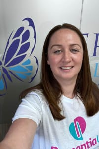 Director and Registered Care Manager, Suzanne, wearing a white t-shirt with the Dementia UK logo on it.